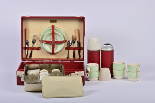 PICNIC SET: A mid-century Brexton picnic set with two Thermos, a food container, three condiment jars and an associated set of six Brexton porcelain gilt rim trios, the case 30cm high, 40cm wide, 13.5cm deep