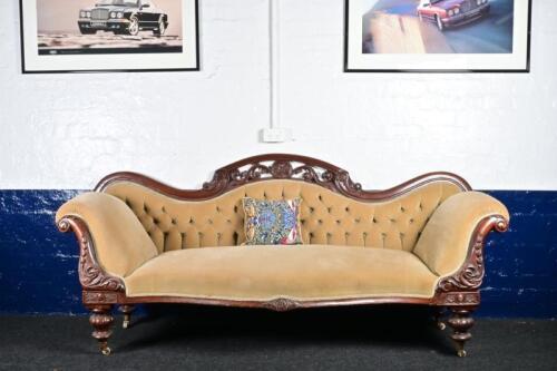 SETTEE: A Victorian velvet upholstered carved mahogany camel back settee, length of back 222cm