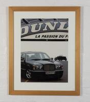 BENTLEY: A showroom display photographic print featuring an Arnage on a racetrack with a WO in the background, mounted, framed and glazed, image 68.5cm high x 50cm wide,