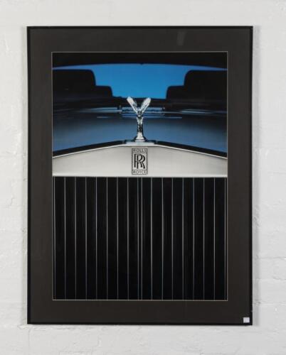 ROLLS-ROYCE: A showroom photographic print depicting a Rolls-Royce grill and spirit of ecstasy mascot, image 82cm high x 58cm wide