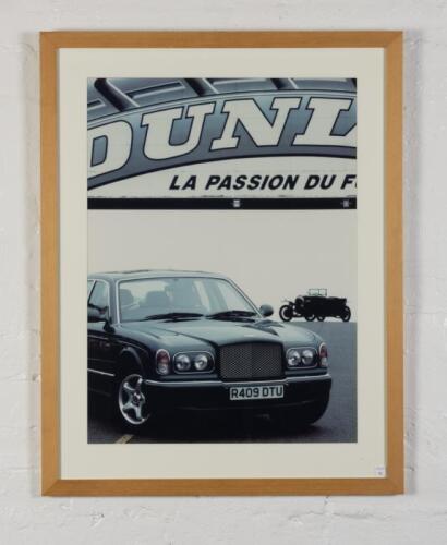 BENTLEY: A showroom display photographic print featuring an Arnage on a racetrack with a WO in the background, mounted, framed and glazed, image 68.5cm high x 50cm wide,