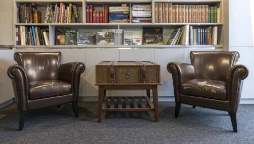COFFEE TABLE: A modern timber trunk style coffee table 66cm high x 73cm wide, with a pair of vinyl armchairs