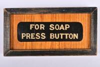 VICTORIAN RAILWAYS: A framed wooden panel 'For Soap Press Button' from a wooden bodied carriage, 12 x 24cm