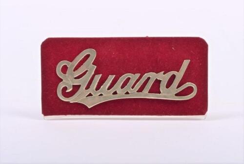 SOUTH AUSTRALIAN RAILWAYS: A brass 'Guard' cap badge, on stand, 8cm long