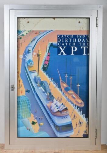 COUNTRY LINK: XPT promotional poster 'Catch Sydney's Birthday' in lockable glass and aluminium station poster display cabinet, 25cm high, 85cm wide, 7cm deep