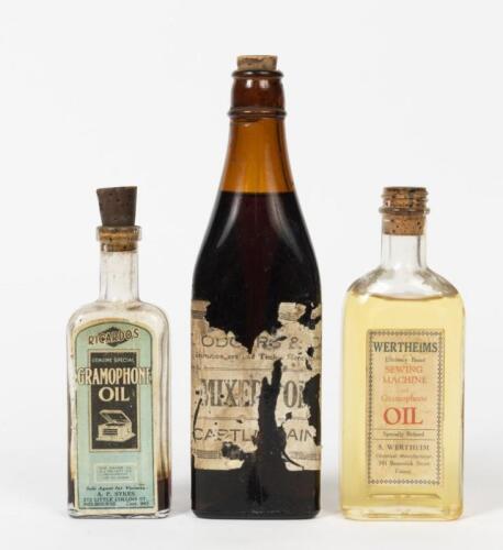 OIL BOTTLES: Three corked glass bottles containing household oils, the tallest 23cm high