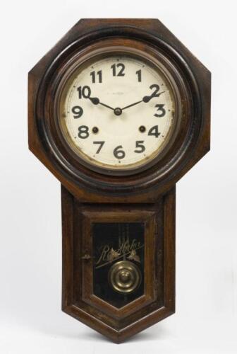 SCHOOLHOUSE CLOCK: An early 20th century Japanese Hudson eight day regulator schoolhouse oak cased wall clock, with key and pendulum, 56cm high, 31cm wide, 11.5cm deep