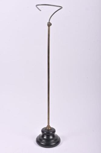 CAP STAND: A brass cap stand with heavy cast iron base, 64cm high