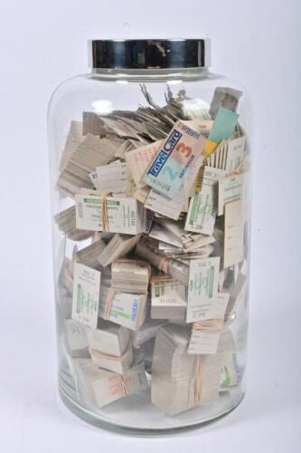 TICKETS: A glass jar filled with mostly V/Line tickets, 35cm high