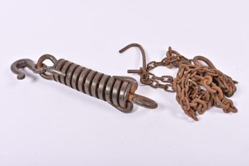 SPRING HOOK: An antique cast iron sprung hook and two lengths of chain, the hook 41cm long
