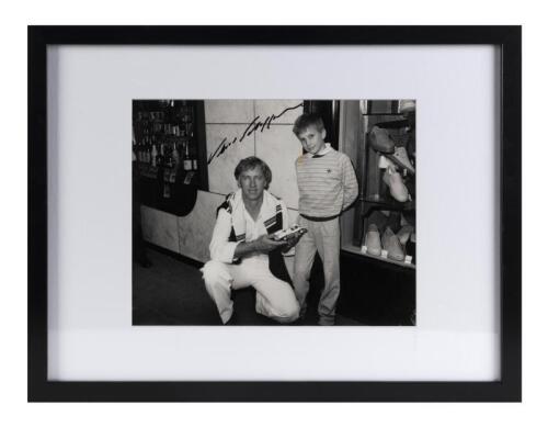 PORSCHE: An original press photograph of Vern Schuppan with boy in mid-1980s Melbourne, signed by Vern, image 19cm high, 24cm wide.