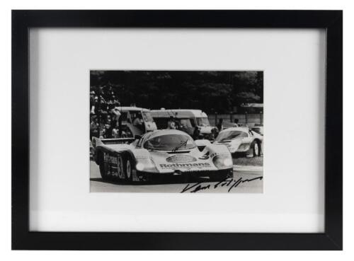 PORSCHE: A period photo of Vern Schuppan in his 956, signed by Vern in black marker, framed