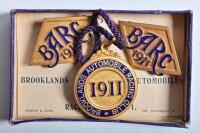 BROOKLANDS: A set of 1911 Brooklands Automobile Racing Club (BARC) lapel badges by Dobson & Sons, set number 1694, in original box
