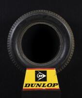 DUNLOP: A circa 1980s plastic Dunlop tyre stand with tyre, 34cm wide x 17cm high.