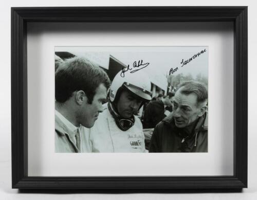 BRABHAM: A hand signed photograph of Sir Jack Brabham and Ron Tauranac in the pits in the mid-1960s, mounted, box framed, 20cm high x 29cm wide.