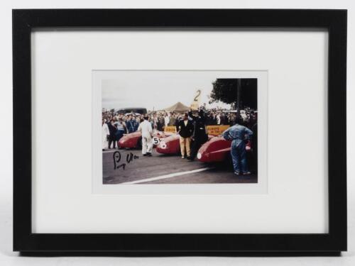 STIRLING MOSS: A small signed colour photograph of Stirling Moss on the 1956 Albert Park Grand Prix, signed framed and glazed, 23.5cm x 32cm wide overall.