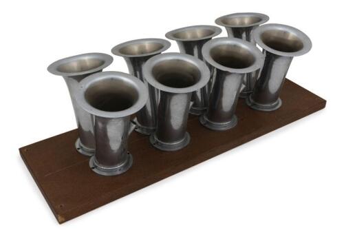 TRUMPETS: Eight decorative chrome metal engine trumpets mounted on timber base