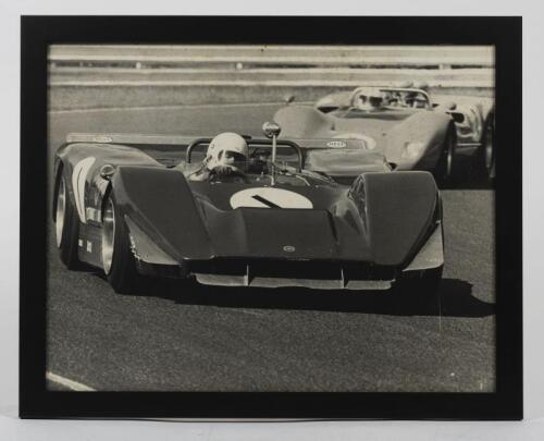 MATICH: An original period photograph of Frank Matich at the wheel of his Matich SR4 at Sandown in 1969 by photographer Peter D'Abbs, 39cm high x 49cm wide
