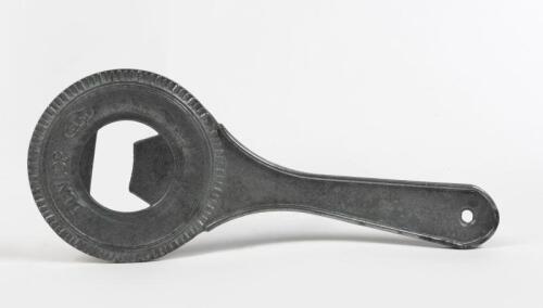 DUNLOP: A circa 1950s cast aluminium tyre form bottle opener,24cm long, 10cm wide