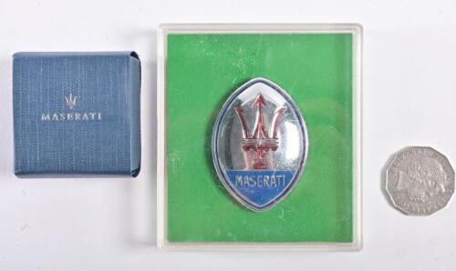MASERATI: Two Maserati display badges, including a trident lapel pin; and a Maserati metal shield form badge 6cm high