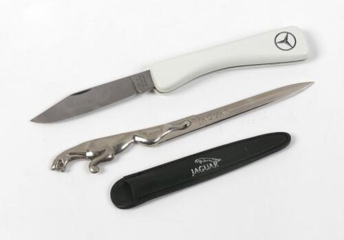 LETTER OPENERS: A Jaguar letter opener in leather sheath and Mercedes folding knife, the letter opener 19cm long