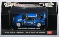 NISSAN: A 1:64 scale NOS Kyosho Nissan Calsonic Skyline 2002 #12 die-cast model