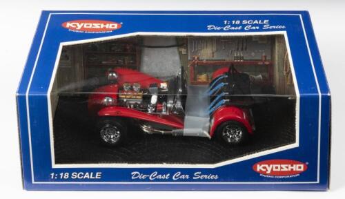 CATERHAM: A 1:18 scale NOS Kyosho Caterham Super Seven clam shell wing red die-cast model