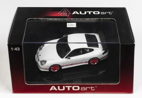 PORSCHE: A 1:43 scale NOS Autoart Porsche 997 GT3 RS white with red stripes die-cast model