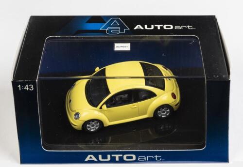 VOLKSWAGEN: A 1:43 scale NOS Autoart Volkswagen New Beetle yellow die-cast model