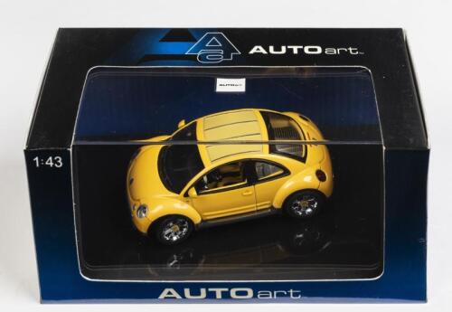 VOLKSWAGEN: A 1:43 scale NOS Autoart Volkswagen New Beetle Dune yellow die-cast model