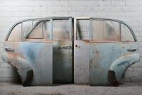 HOLDEN: A set of four FJ Holden doors left front right rear with glass. Right rear missing glass, right front broken glass.
