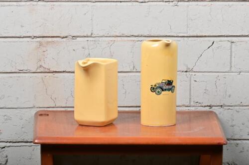 JUGS: Two yellow ceramic jugs, one with Bullnose Morris, other other by Diana
