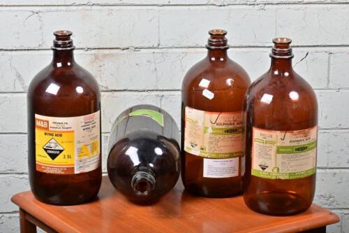 BOTTLES: Four bronze glass acid bottles, empty, 31cm high