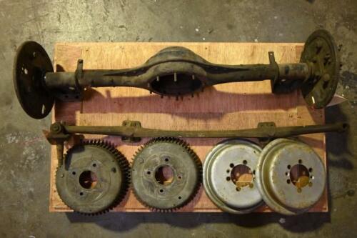 MG TC: A collection of MG TC parts including rear axle.diff housings, front axle and two pairs of drum brake covers, the alloy finned being Datsun