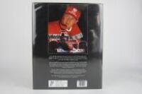 MICHAEL SCHUMACHER: A hardcover book titled 'Michael Schumacher, The Rise of a Genius' by Lue Domenjoz (signed Schumacher) - 2