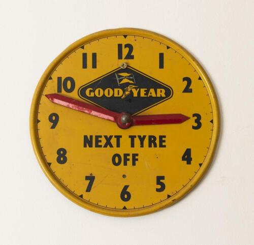 GOODYEAR: An early pressed metal "Next Tyre Off" adjustable workshop clock, 18cm diameter