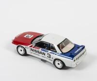 SKYLINE: A 1:18 scale Autoart Nissan Skyline GT-R (R32) as raced by Mark Skaife in 1990 Australian Grand Prix, #3, aerial missing, in double fitted box with COA, box faded - 2