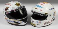 HELMETS: A two white racing helmets with applied racing stickers in large sized