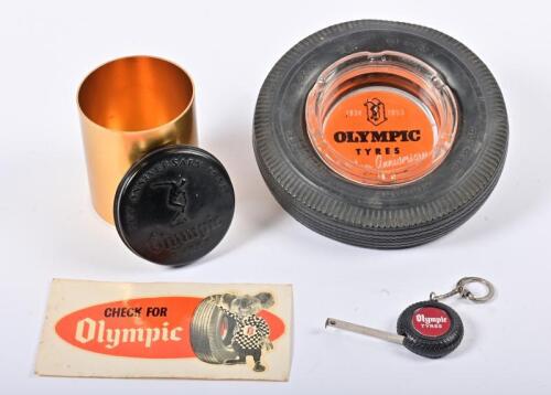 OLYMPIC: A group of Olympic tyres related promotional items, comprising a novelty tyre form ashtray, tape measure, unused sticker and lidded tin, the ashtray 14.5cm diameter