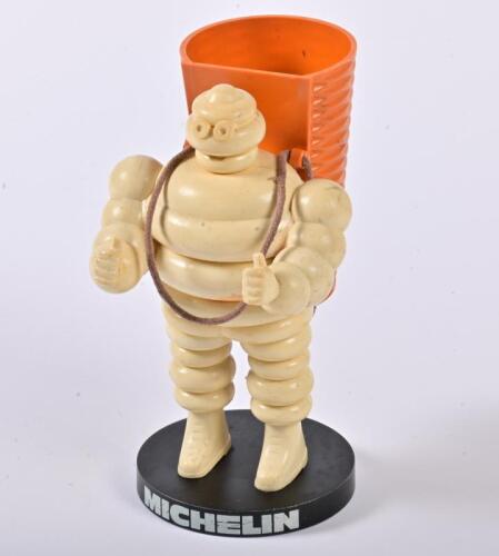 BIBENDUM: A 1970s Michelin Bakelite Bibendum pen holder, with a basket on his back and on stand, 14cm high