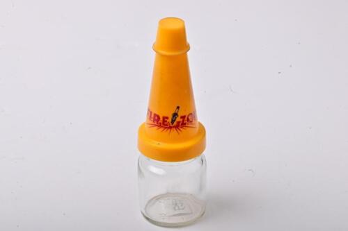 FIREZONE: A small NOS Firezone oil bottle with plastic pourer and cap, with UV damage to the pourer