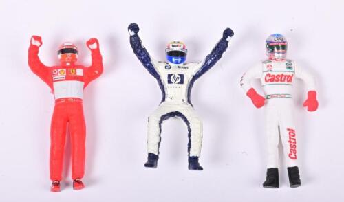 FIGURINES: Three race drivers figurines, one being M.Webber, one being M. Schumacher and one being Russell Ingall
