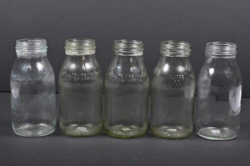 OIL BOTTLES: A collection of five one litre oil bottle, some with bottle rash