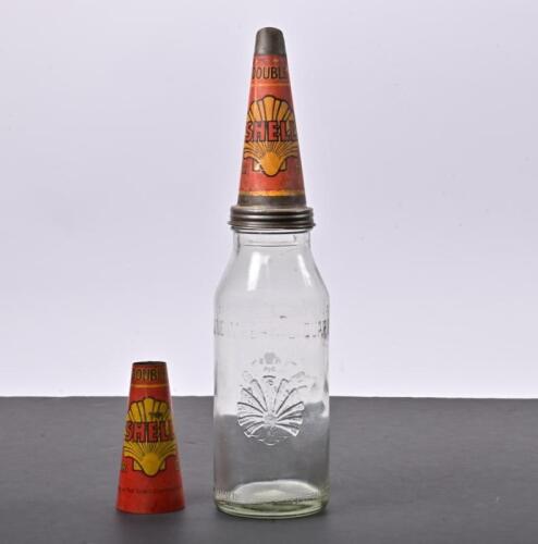 SHELL BOTTLE: A 1930s Shell one imperial quart embossed glass bottle and tin pourer with another pourer sleeve that was riveted and overlaid the original pourer
