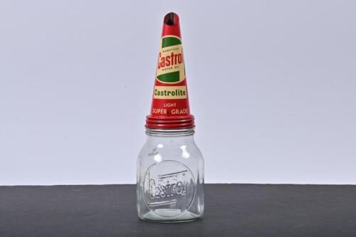 CASTROL WAKEFIELD: A one imperial pint Castrol Wakefield embossed glass oil bottle with a rare NOS Castrolite Castrol Wakefield motor oil tin pourer with the sought after "Wakefield" inclusion in the "flash" logo