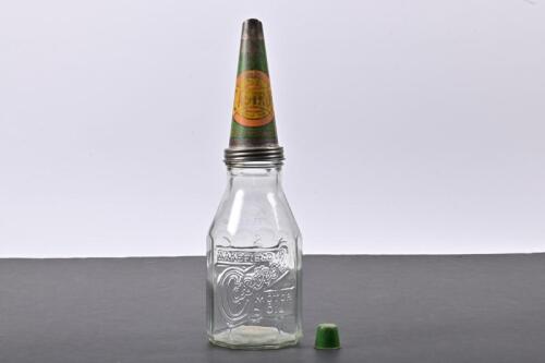 CASTROL WAKEFIELD: An early embossed one imperial quart Castrol Wakefield glass oil bottle with a AA Medium Castrol Wakefield motor oil tin pourer
