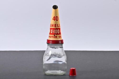 SHELL: A one pint glass oil bottle with NOS Shell X-100 tin oil pourer and dust cap