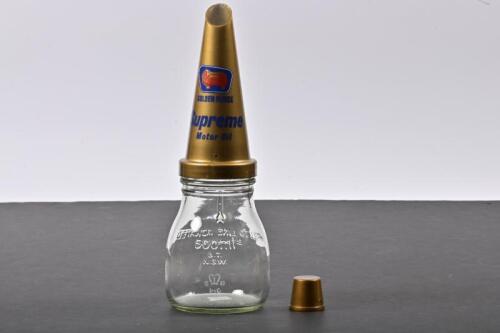 GOLDEN FLEECE: A five hundred millilitre oil bottle with NOS plastic Golden Fleece Supreme Motor Oil pourer