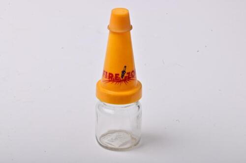 FIREZONE: A small NOS Firezone oil bottle with plastic pourer and cap, with UV damage to the pourer