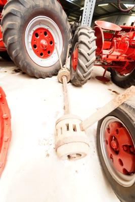 A Metal axle with wooden wheel hubs 